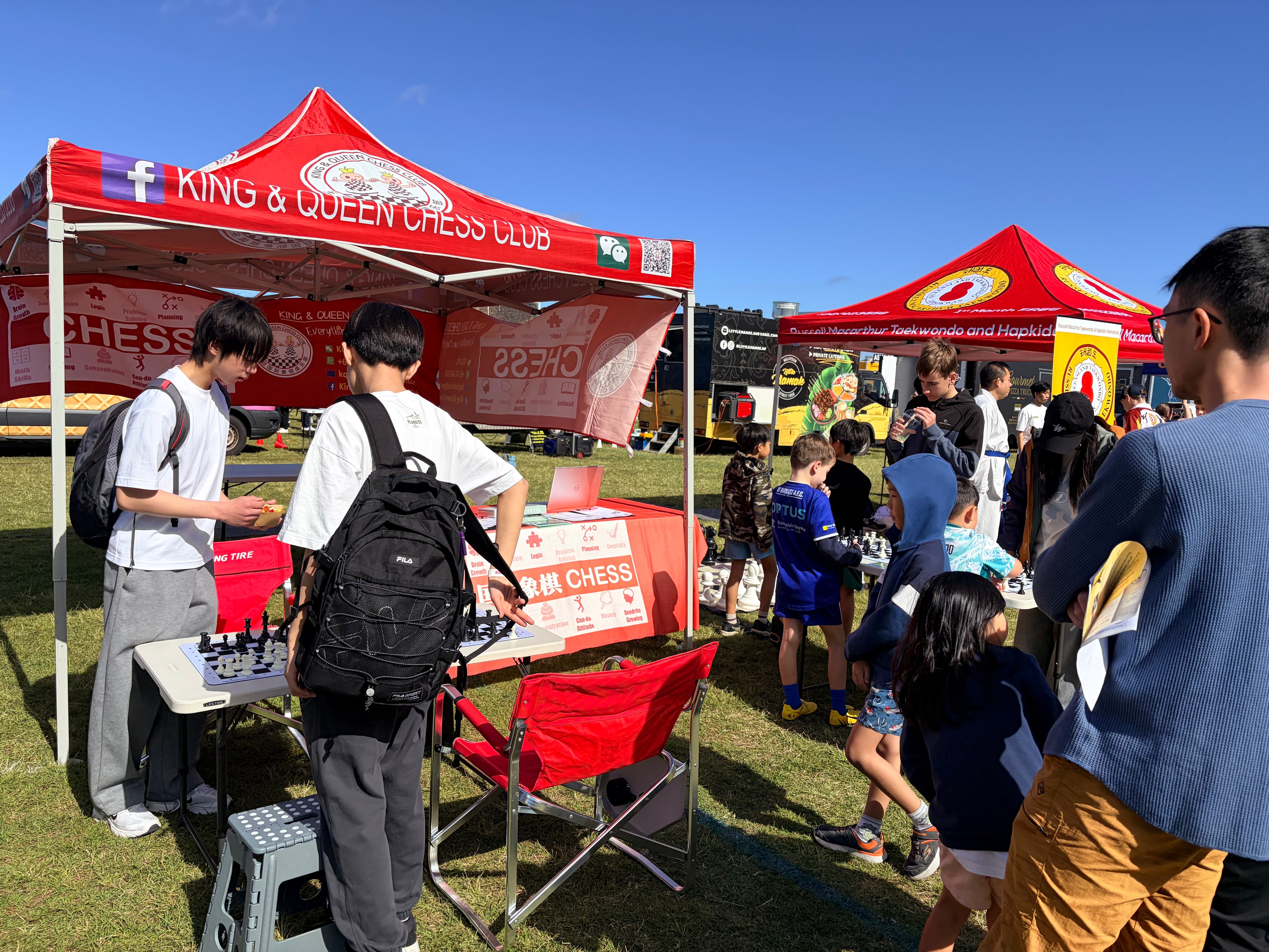 Visitors gathering around the community chess booth