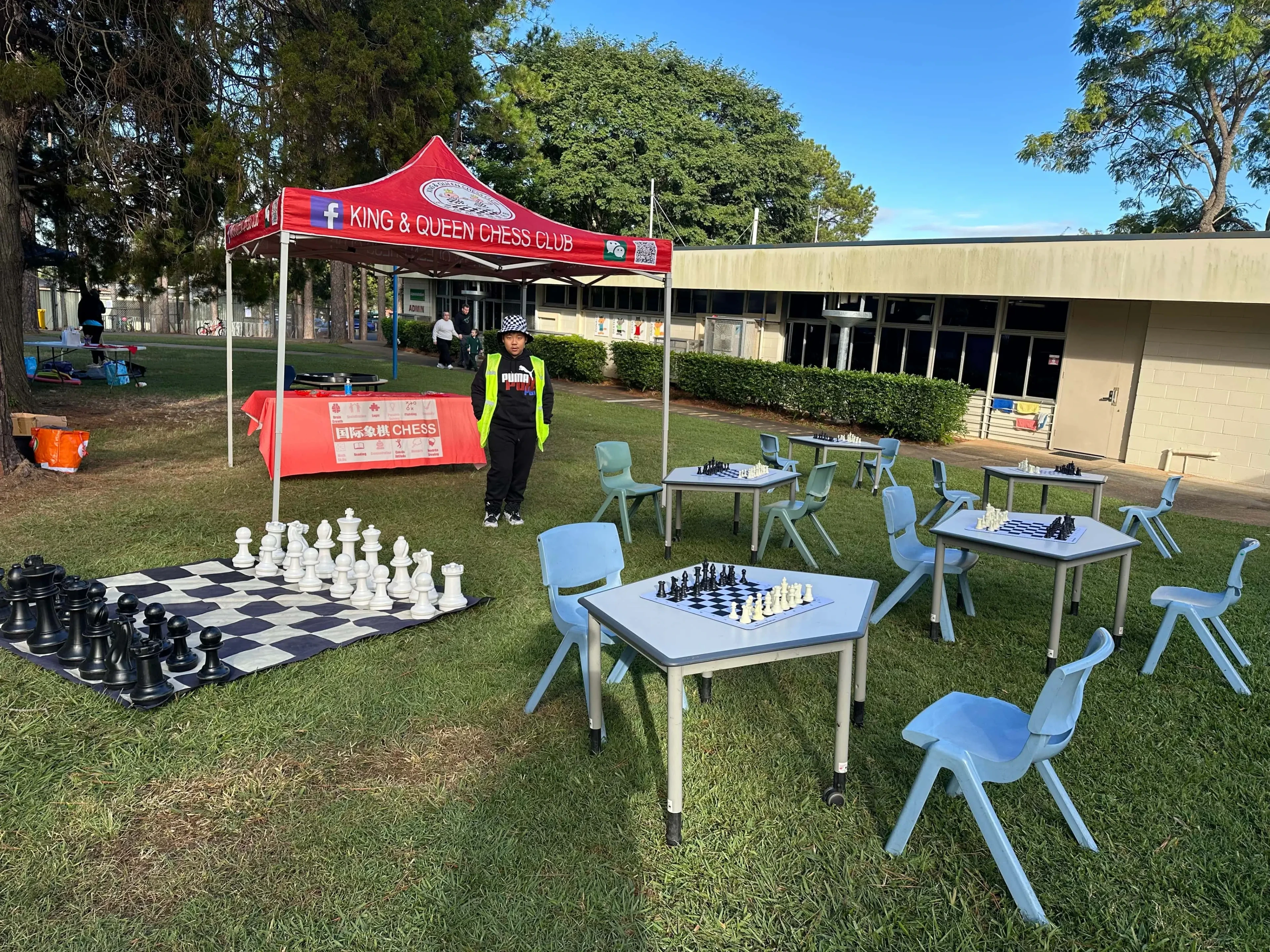 Queensland Chess School marquee and giant chess at a school community event
